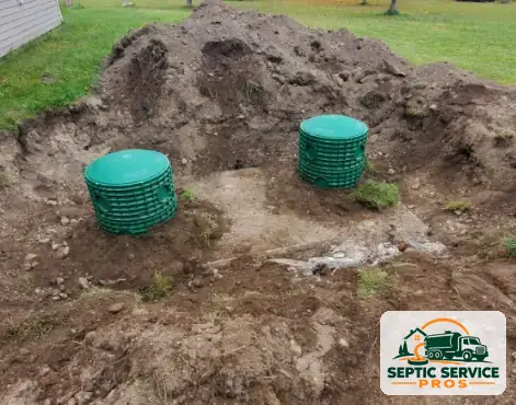Two green septic riser lids installed at ground level over a tank